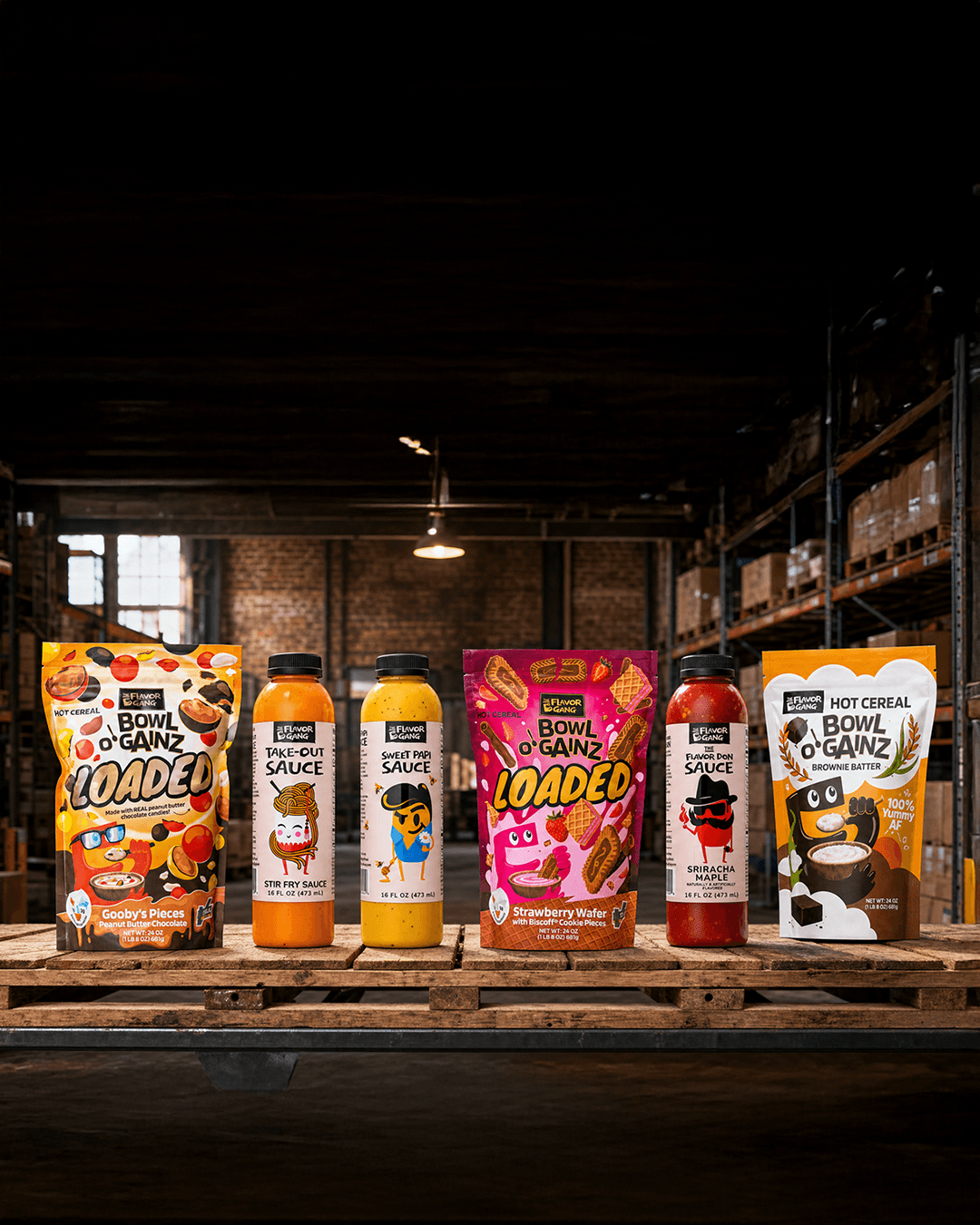 The Flavor Gang lineup on a warehouse pallet: Bowl O' Gainz Loaded hot cereal with Flavor Don, Sweet Papi, and Take-Out sauces.